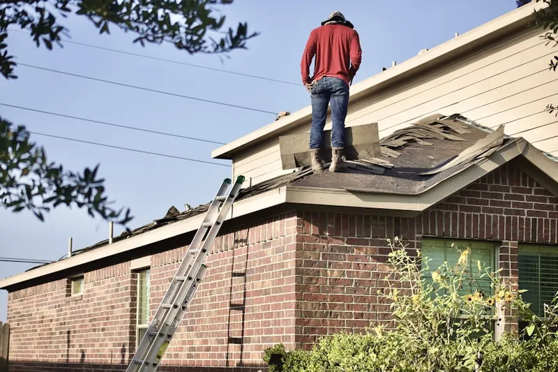 Professional roofer working on a residential roof in West Yarmouth